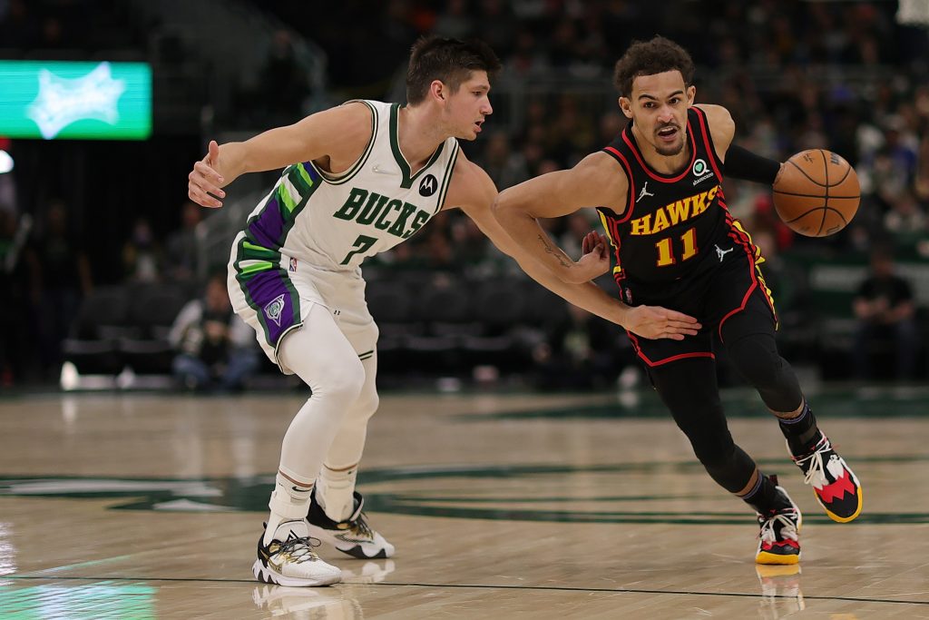 MILWAUKEE, WISCONSIN - MARCH 09: Trae Young #11 of the Atlanta Hawks drives around Grayson Allen #7 of the Milwaukee Bucks during a game at Fiserv Forum on March 09, 2022 in Milwaukee, Wisconsin.  NOTE TO USER: User expressly acknowledges and agrees that, by downloading and or using this photograph, User is consenting to the terms and conditions of the Getty Images License Agreement. (Photo by Stacy Revere/Getty Images)